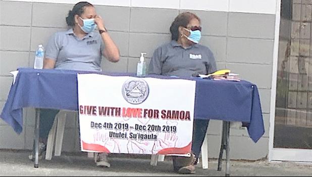Two ASG workers wearing protective nose/ mouth masks,