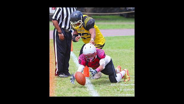 Faga’itua’s Jefferey Ulu inches away from trying to save this pass inbounds – during their varsity match against the Wildcats last Saturday. Ulu helped the Vikings in their 14 - 28 victory over the Wildcats. [photo: TG]