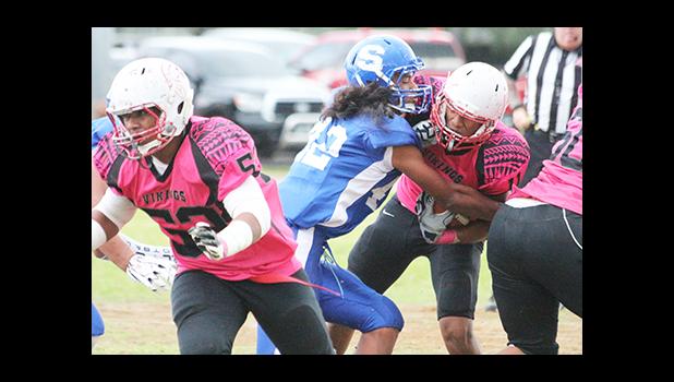Samoana Sharks defensive end, Antonio Pule III – wrapping up Vito Kitiona in the backfield for a loss, during the first half of their varsity match last Friday evening, as the opening game for the final week of regular season. Samoana defeated the Vikings 24 - 22. [photo: TG]