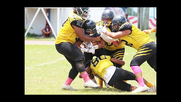 A host of Wildcats swarm Tafuna’s Andrew Toilolo in the backfield for a huge loss, in the second half of their Varsity game last Saturday – it was Tafuna’s Senior Game, and Nu’uuli spoiled it with a 28 - 20 victory, for the ‘upset’ of the season. A fitting end to their final game of their ASHSAA football season — on a very high note! [photo: TG]
