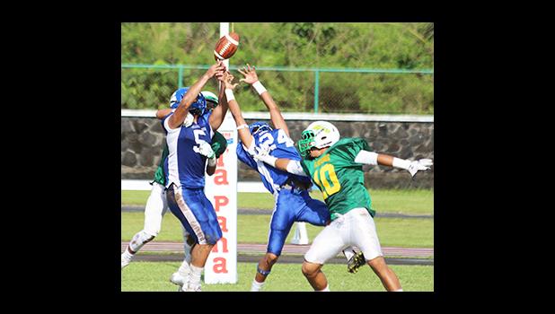 Samoana Sharks safety Cornelius Aiava (5) tries to intercept a pass from Lions quarterback Ma’ae, intended for Ali’itoa Langkilde in the first half of their varsity match up this past Saturday. Leone Lions won 28– 7 against the Samoana Sharks.  [photo: TG]