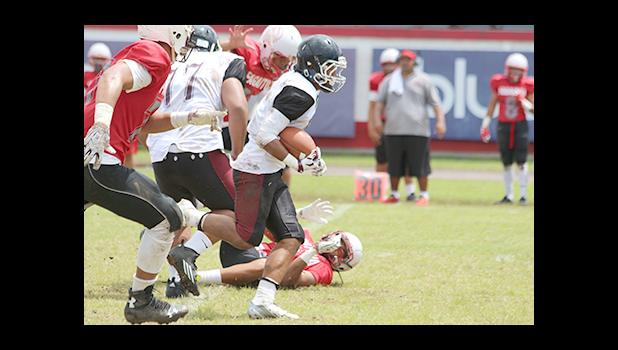 Tafuna Warriors Gilboy Papali’i storming through the middle to score his first touchdown of the game against the Vikings this past Saturday – Warriors won 28- 16. [photo: TG]