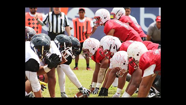 Warriors and Vikings at the line of scrimmage during their Battle of the Toa’s rivalry match up last Saturday, which Tafuna won 28- 16. [photo: TG]