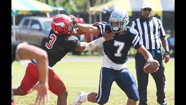 Samoana Sharks quarterback Viliamu Tanielu trying to hold off a vicious blitz by Ronnie Oa of