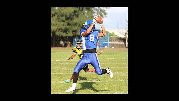 Ralph Taufa’asau with the two-hand grab as he catches this long bomb from his quarterback, for a huge Samoana gain. Taufa’asau scored two touchdowns in their 13 - 6 win against the Wildcats last Friday evening. [photo: TG]