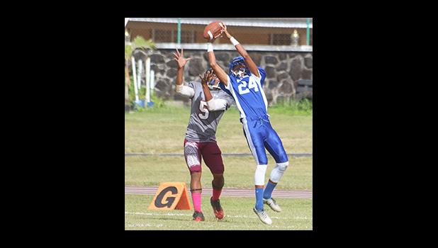 Sophomore cornerback for the Sharks, Elliot Lelei with the touchdown saving interception in the first half of their varsity game against the Warriors last Saturday morning.  [photo: TG]