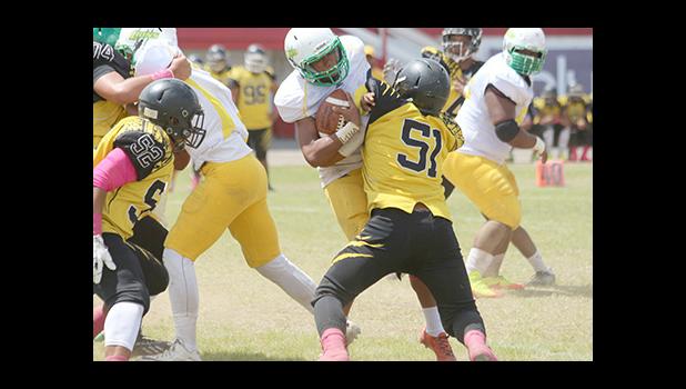 Leone Lions Luteru Ah Loe gets tackled hard there by Branson Pualau of Nu’uuli during their varsity match last Saturday. They tied 20 - 20 as of results. [photo: TG]
