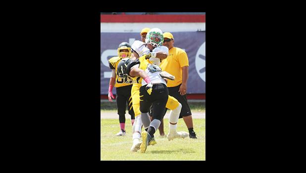 Juliano Falaniko, star linebacker out of Leone High School just seconds away from slamming this Wildcat to the ground near halftime of their varsity match last Saturday. They tied Nu’uuli 20 - 20. [photo: TG]