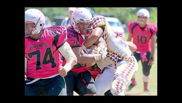 Vikings bruising running back muscling his way through midfield as a Warrior defender attempts to strip the football. [photo: TG]