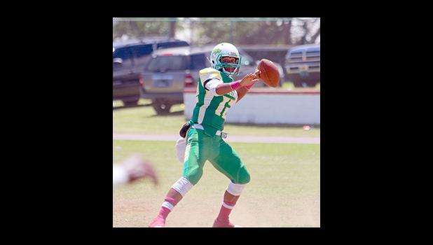 Leone Lions quarterback Ronnie Maae attempts a pass in the second quarter of their varsity match up against the Sharks last Saturday – Leone lost 6 - 0 to the Sharks. [photo: TG]
