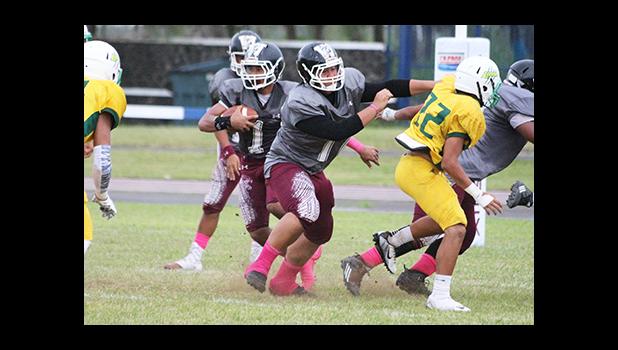 Warriors offensive lineman Marvin Atuatasi opening a huge gap for Panapa Filoiali’i at midfield, during the opening half of their varsity match against the Lions last Friday evening – Tafuna shut out Leone and claimed victory in their 38 point win.  [photo: TG]