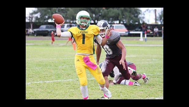 Iverson Ta’ase of Leone, looking downfield and attempting a pass in the second quarter of play, as he returned to the field after a two game absence due to injury. [photo: TG]