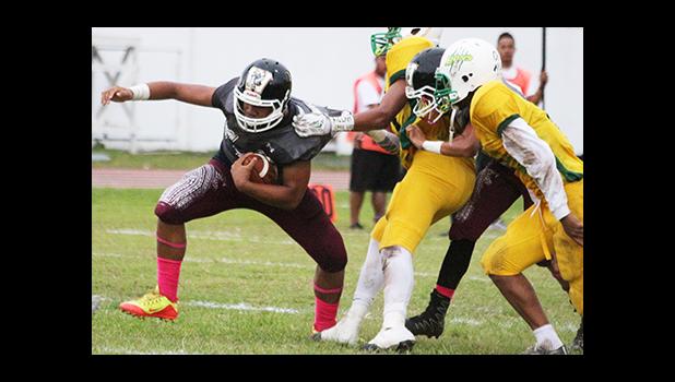 Jr. Sufia of the Warriors trying to break this tackle, as he is one of the most explosive skill players for Tafuna to field this year. Sufia helped the Warriors in their 38- point victory over Leone. [photo: TG]