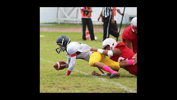 Iosefa Mauga of Nu’uuli gets tackled short of the first down marker in the second half of their JV match against the Vikings last Saturday, as the second game of the triple header for ASHSAA Football Week No. 9. [photo: TG]