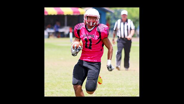 Vito Kitiona at the sidelines storming towards the end zone for a huge Faga’itua gain in the opening quarter of their match against Nu’uuli last Saturday afternoon. Kitiona helped the Vikings in their 14 - 28 comeback victory against the Wildcats.  [photo: TG]