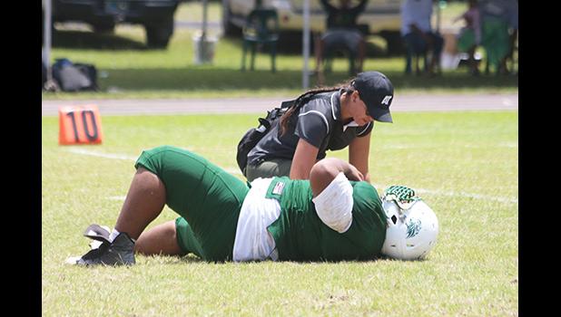 Florence Wasko tending to one of the many injured in Saturday's games, this time it is Cyan Fiatoa