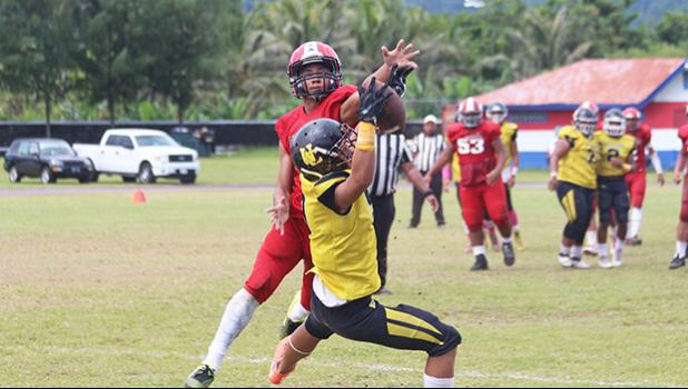 PJ Tufugafale securing a catch against Faga’itua’s Tevita Tevita 