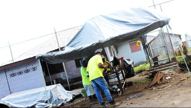 Construction workers seen last Friday afternoon, working on erecting a perimeter wall at the Territorial Correctional Facility.