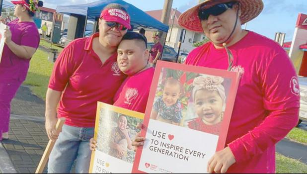 Famlies with signs at World Hearts Day wave