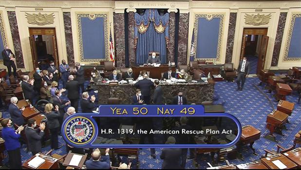 In this image from video, the vote total of 50-49 on Senate passage of the COVID-19 relief bill, is displayed on screen in the Senate at the U.S. Capitol in Washington, Saturday, March 6, 2021. (Senate Television via AP) Total Senate vote