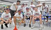 Members of the 18U Amerika Samoa National Baseball team post inside the library at Juan M. Guerrero Elementary school with the 5 Star Legacy National Baseball Team.