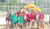ASVBA President Ben Sauvao flanked by Paul and Pam Von Dinklage and young volleyball players