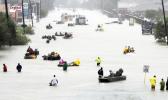 Rescue boats fill a flooded street as flood victims are evacuated as floodwaters from Tropical Storm Harvey rise Monday, Aug. 28, 2017, in Houston. (AP Photo/David J. Phillip)