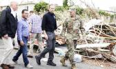  President Trump walks with FEMA administrator Brock Long (second from right) and Lt. Gen. Jeff Buchanan (right) as he tours an area affected by Hurricane Maria in Guaynabo, Puerto Rico, on Oct. 3. [Evan Vucci / AP]