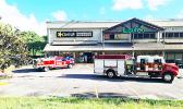 Fire trucks and EMS personnel in front of Carl's Jr