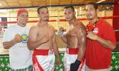 Two professional fighters from American Samoa — Paofe Seeti (second from left) and Ofisa Talaimalo (third from left) with their coach and trainer, Sala Sanele Etuale (left). [photo by AF]