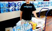 ASCC student Feliciamere P. Elisara, whose Vailoa home was destroyed by Cyclone Gita, receives food, water and clothing during the College’s assistance drive last week for students affected by the cyclone. The ASCC Marketing Committee organized effort, with assistance from the Student Government Association and the College’s student clubs.  [Photo: J. Kneubuhl]