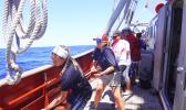During an oceanographic research sail aboard the vessel “Robert C. Seamans,” Sea Education Association staff lead ASCC students in the appropriate line hauling method to raise the main sail, the largest sail on the ship. (Photo. S. Woofter) During an oceanographic research sail aboard the vessel “Robert C. Seamans,” Sea Education Association staff lead ASCC students in the appropriate line hauling method to raise the main sail, the largest sail on the ship. (Photo. S. Woofter)