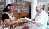 ASCC Samoan Studies Institute Director Mrs. Okenaisa Fauolo-Manila (left) receives a gift of books on the Tahitian language from Bishop Hubert Coppenrath of the Tahitian Academy during the recent Polynesian Festival hosted in Papeete by Te fare Tahiti Nui (also known as the Maison de la Culture).  [Photo: T. Mulitalo-Cheung]