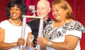 In this photo: (right) President Isapela Coggins is presented the American Samoa Society’s National Trophy by last year’s winner, (left) Diane Parrot, who represents the Virgin Islands Society, along with (center) NCSS President William Christian.  [Courtesy photo]
