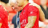 Canada National Coach, Damen McGrath, embraces his Samoan heritage player, Mike Fuailaefau, after a 28-15 thrashing of Russia.  Ironically Coach McGrath is still in litigation with the Samoa Rugby Union for what he believes was an unjust termination.  Singapore Sevens, Day 1, National Stadium, Singapore.  [Photo: Barry Markowitz]