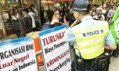Hong Kong Police oversaw Indonesian domestic workers protesting against working conditions, agent fees in an organized demonstration in Causeway Bay, Hong Kong.  [Photo: Barry Markowitz]