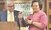 University of Guam president, Dr. Robert Underwood presenting Congresswoman Aumua Amata with the 2017 Distinguished Alumnus Award.  [photo: courtesy]