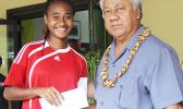Elcy Lui, left, of Vaiala Tongan’s 13-15 girls team receives her MVP award for the 2017 FFAS Summer Youth League from Sen. Faiivae Iuli Alex Godinet on July 15 at Pago Park Soccer Stadium. [FFAS MEDIA/Brian Vitolio] 