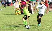An SPA player, right, and St. Theresa opponent, left, of the Girls 6-8 division in action on Match Day 2 of the 2016 FFAS Private Elementary Schools soccer league at the Kanana Fou Seminary Field on Thursday, Oct. 20, 2016.   [FFAS MEDIA/Brian Vitolio]