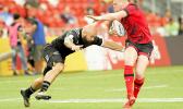 NZ Joe Ravouvou plays with a Wales defender as he scores a try in the All Blacks 36-14 victory over Wales at the Singapore Sevens, Day 1, National Stadium, Singapore. [Photo: Barry Markowitz]