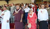 Front row, standing on stage at Veterans Memorial Stadium during the raising of the United States and American Samoa flags at Monday’s 2017 Flag Day ceremony. [l-r] Catholic Deacon  Malaki A. Timu o le the Holy Family Parish Fatuoaiga, Chief Justice Michael Kruse and Masiofo Filifilia Tamasese with Samoa Head of State Tui Atua Tupua Tamasese Efi, who delivered the Flag Day keynote speech. [photo: AF] 0771