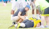 American Samoa’s only Certified Athletic Trainer Florence Wasko attended the IOC World Conference last week for an update on the latest within the field of sports medicine. She works for ASDOE — Athletic Division — and is seen here during a local football game treating a player who was injured during play.  [SN file photo]