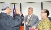 Associate Judge Suapaia Pereira (far left) administers the oath of office for the new Western District Governor, Fuamatu J.V. Fuamatu, (middle) at the Governor’s Office Conference Room yesterday morning. Holding the Bible is Fuamatu’s wife. [photo: AF]