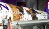 Hawaiian Airlines revealed last Saturday the first of three “Moana” themed planes at its home base at Honolulu International Airport.  Pictured on the stairs are Auli‘i Cravalho, the Hawaiʻi-born actress who is the voice of Disney’s “Moana,” and Dwayne ‘The Rock’ Johnson, the voice of demigod Maui, and were among the first to see the new design. [Photo: Donald Traill for Hawaiian Air]