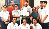 Pictured are the students from Manumalo — with their $600 check — along with one of American Samoa's three members on the Council, Taotasi Archie Soliai, and Dept. of Marine and Wildlife Resources director Va'amua Henry Sesepasara. [photo: BC]