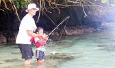 One of the youngest participants in this year's Sanctuary Summer Science in the Village (SSSV) program, learning how to properly use a fishing pole during one of four Tautai Fagota Fishing Derbies  hosted by the NMSAS and local sponsor SOPAC/Aloha Maid.  [photo: BC]