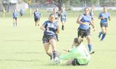 Rapiel Fa’ata’a (#4) of SPA dribbles inside Samoana’s penalty area while the Sharks’ goalie Mele Tialavea slides in for a save in a 2016-17 ASHSAA Girls Soccer playoff game at Pago Park Soccer Stadium on Monday, March 20, 2017. SPA, ranked #3, won the game in penalty shootout against the No 2 ranked SHS. The championship title game is set to kick off today at 4:00 p.m., to be followed by a short awards ceremony.  [FFAS MEDIA/Brian Vitolio]