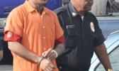 Former TCF warden, Foifua Foifua escorting prison escapee Joe Togitogi to the District Court yesterday morning for his initial appearance.  [photo: AF]