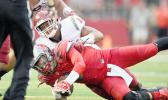 Rutgers quarterback Chris Laviano is greeted by Washington State linebacker Logan Tago, during the Washington Sate Cougars win of 37-34 last September. Read story left about Tago’s Monday arrest on suspicion of a felony robbery and second-degree assault. [photo: Rich Kane / AP]
