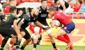 NZ All Blacks 7s Captain, DJ Forbes, demonstrates perfect form in setting up to tackle a Scotland player in NZ's 22-21 victory over Scotland at the Singapore Sevens, Day 1, National Stadium, Singapore.  [Photo: Barry Markowitz]